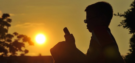 A Cuban boy uses his mobile phone on Jun